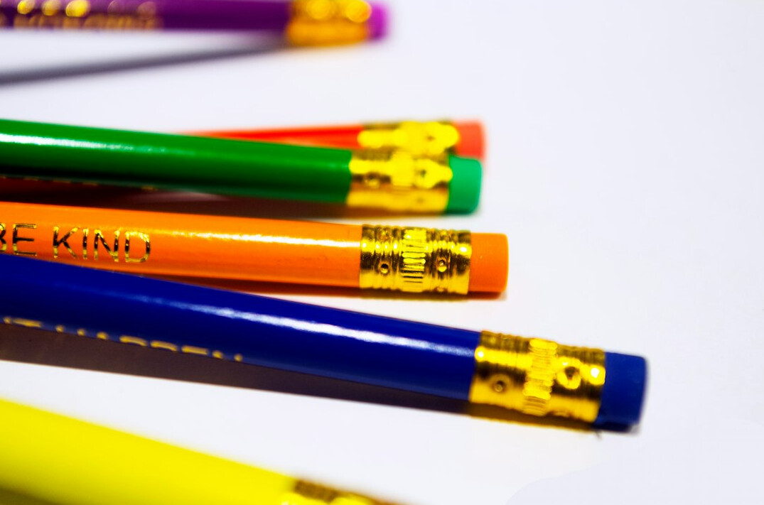 Notes and sketches on a desk with pencils