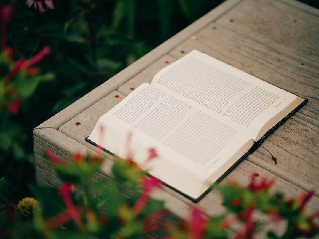 Stack of books and an open book on a table